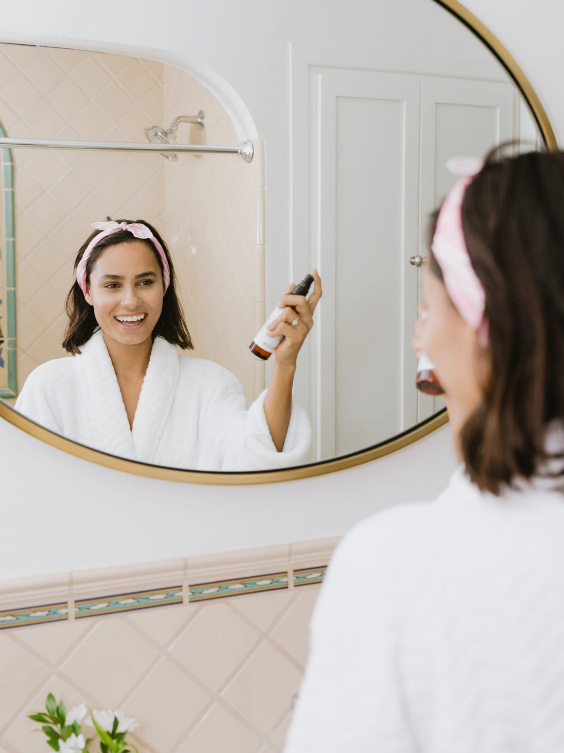 woman spritzing skin